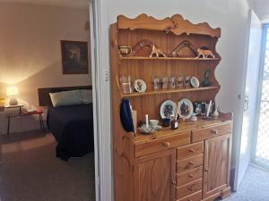 a bedroom with a wooden dresser and a bed at Kimba Units in Kimba