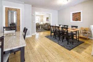 a kitchen and living room with a table and chairs at The Gray House by Gallaudet 4 BR 3 BA in Washington
