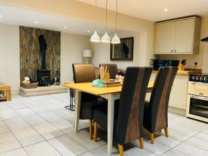a kitchen and dining room with a table and chairs at The Stables in Bakewell