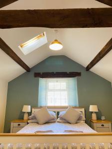 a bedroom with a large bed with a window at The Stables in Bakewell