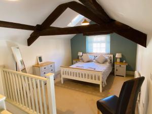 a bedroom with a bed and a crib and a window at The Stables in Bakewell