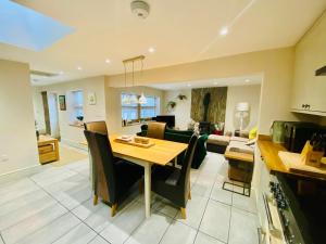 a kitchen and living room with a table and a couch at The Stables in Bakewell