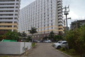 a parking lot in front of a large building at Dencio's Crib in Mactan