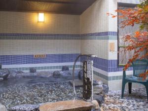 a hot tub in the corner of a building at Dormy Inn Premium Kyoto Ekimae Natural Hot Spring in Kyoto