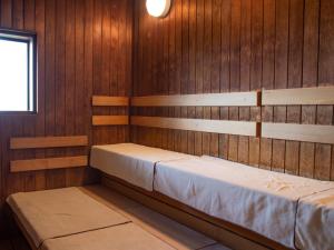 a room with two beds in a wooden wall at Dormy Inn Premium Kyoto Ekimae Natural Hot Spring in Kyoto