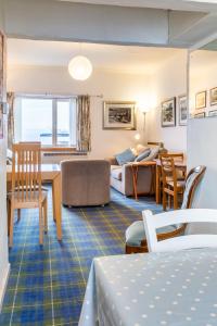 a room with a living room and a bedroom at Beach Front Flat, Brodick in Brodick