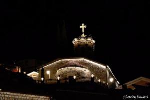 a church with a cross on top of it at night at Apartments Center in Ohrid