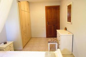 a small room with a refrigerator and a toilet at Christie's ground floor apartment by the sea in Kato Gatzea +25 photos