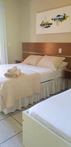 Cama ou camas em um quarto em Pousada Guaruja mais 37 fotos