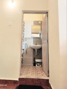 uma casa de banho com um lavatório e um espelho em Monte Villa Guest House em Candolim
