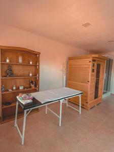 a ping pong table in a room with wooden shelves at Buenos Vientos Complejo - Termas Chajarí in Chajarí