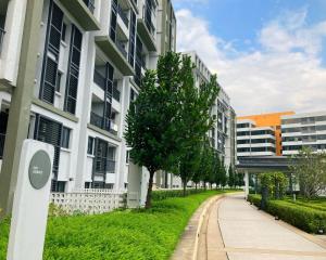 a sidewalk in front of some buildings with a tree at Radia Residence Block E lobby 2 in Shah Alam