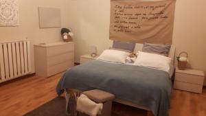 a bedroom with a bed with a dog sitting on it at Suite Re Riccardo in Caserta
