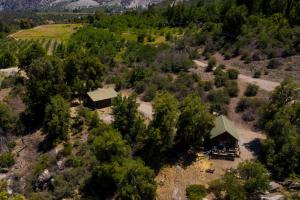 an aerial view of a cabin in a field with trees at Cabañas Emporio de la Meme in San José de Maipo