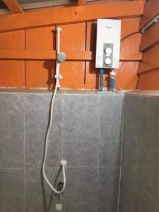 a shower in a bathroom with a microphone at The Wavy Sailor Bungalow's in Koh Rong Island