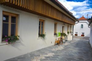 een wit gebouw met ramen en een patio bij CUBE central rooms for 2 in Ljubljana