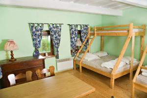 a bedroom with two bunk beds and a table at Chata Donovaly in Staré Hory