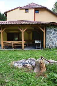 a house with a log in front of it at Chata Donovaly in Staré Hory