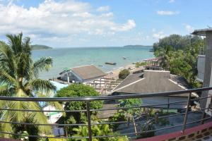 a view of a beach and the ocean from a balcony at The Seaview Residency in Port Blair