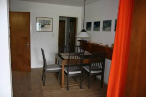 a dining room and kitchen with a table and chairs at Salve 8 in Leukerbad