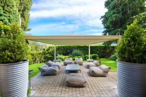 a patio with a group of couches and a canopy at Villa Sassolini Country Boutique Hotel in Montevarchi