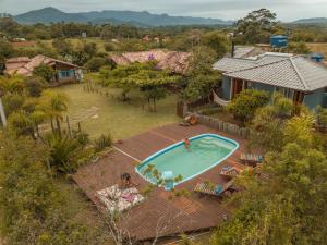 an aerial view of a house with a swimming pool at Pousada Waikiki in Praia do Rosa