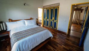 a bedroom with a bed and a wooden floor at Termales El Otoño in Manizales