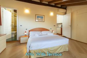 a bedroom with a large bed and a bathroom at BolognaRoomscom - Santo Stefano Apartments in Bologna