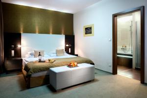 A bed or beds in a room at Hotel Turiec