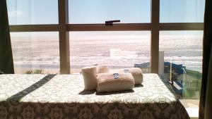 a bedroom with a bed with a view of the ocean at Hotel SKY in San Bernardo