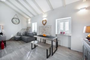a living room with a table and a couch at Jully apartment with swimming pool in Babino Polje