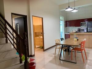 a kitchen and dining room with a table and chairs at Gardens by the bay in Taitung City