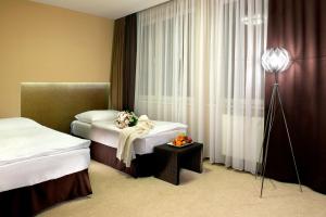 A bed or beds in a room at Hotel Turiec