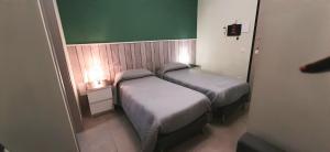 A bed or beds in a room at Guest House Roma Express