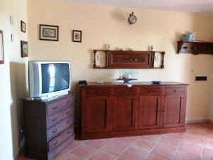 a television on a dresser with a tv on top at Villa Su Trechesu in Orosei +62 photos