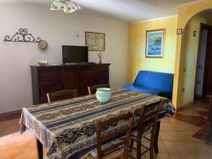 a dining room with a table with a bowl on it at Villa Su Trechesu in Orosei