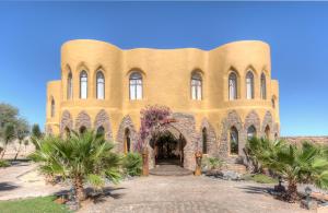 a large building with trees in front of it at Le Mirage Resort & Spa in Sesriem