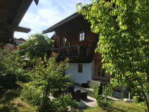 a wooden house with a balcony on the side of it at Webergütl in Inzell