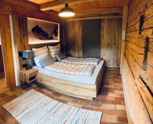 a bedroom with a bed in a wooden room at Webergütl in Inzell