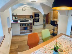 a kitchen with a table and chairs in a room at Webergütl in Inzell