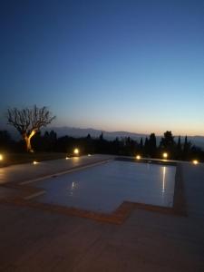 an empty parking lot at night with a tree at Il Roccolo Di Valcerasa in Treia