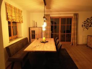 a living room with a table and a couch at Ferienwohnung Hahnenkammblick in Kitzbühel