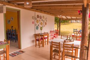 a dining room with a table and chairs at Pousada Waikiki in Praia do Rosa