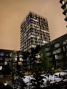 a tall apartment building with its lights on at Apartment David Garden Towers in Prague