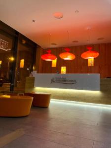 a restaurant with red lights on the wall and benches at Apartment David Garden Towers in Prague