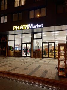 a store front of a pharmacy market at night at Apartment David Garden Towers in Prague