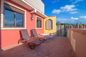 two chairs and a table on a patio at Cassorova Hotel Boutique in Brotas