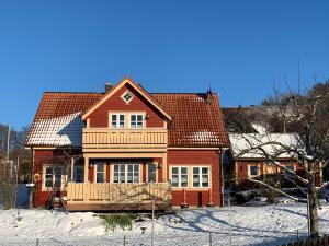 a house with a deck in the snow at Holzferienhaus in Gößweinstein
