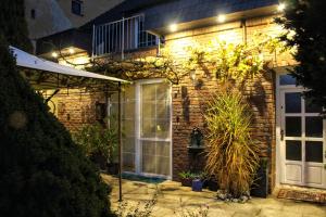 a brick house with lights on the side of it at Apartmán Za kopcem in Boskovice