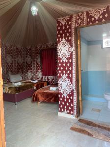 a bedroom with a bed and a toilet in a tent at Sand Star Camp in Wadi Rum